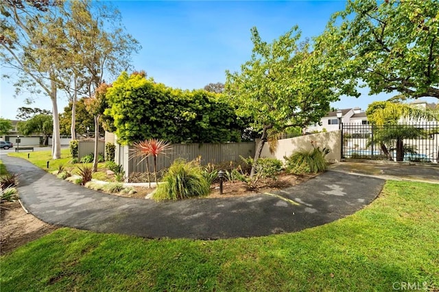 view of home's community with a fenced front yard and a yard