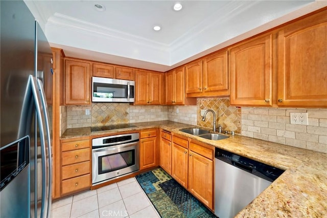 kitchen with crown molding, light tile patterned floors, brown cabinets, stainless steel appliances, and a sink