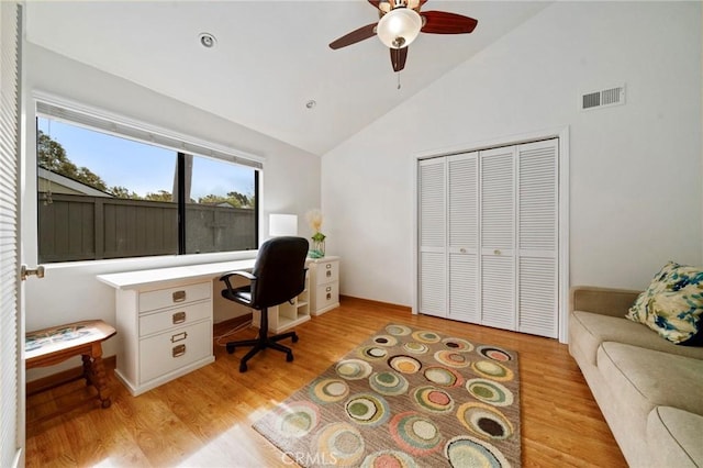 office area featuring ceiling fan, visible vents, light wood-style flooring, and vaulted ceiling