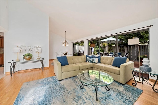 living area featuring high vaulted ceiling and wood finished floors