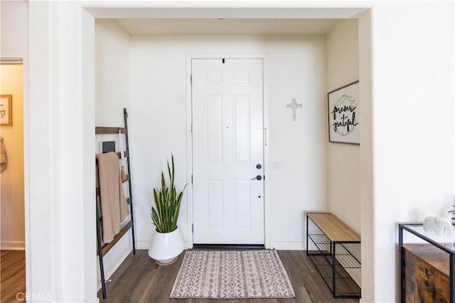 foyer entrance featuring dark wood-style floors and baseboards