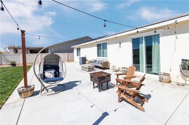 view of patio featuring an outdoor living space with a fire pit, central air condition unit, and a fenced backyard