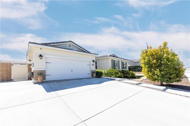 view of front of house with stucco siding, driveway, and a garage