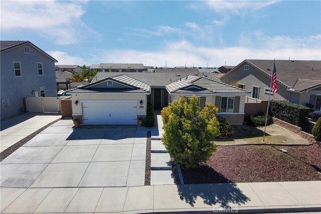 ranch-style home with fence, a tile roof, concrete driveway, stucco siding, and an attached garage