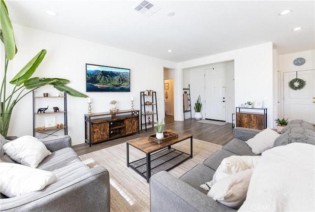 living room featuring recessed lighting, wood finished floors, and visible vents