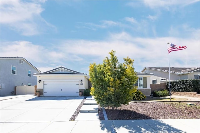 ranch-style home featuring concrete driveway, fence, a garage, and stucco siding