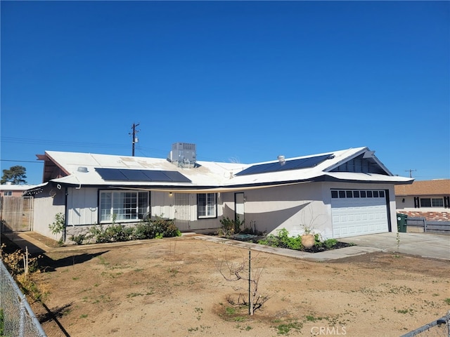 316 Mcbroom Ave, Barstow, CA 92311 - single story home with a garage, roof mounted solar panels, concrete driveway, and fence