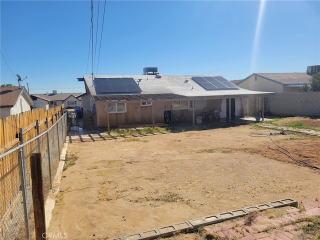 316 Mcbroom Ave, Barstow, CA 92311 - rear view of house with solar panels, a fenced backyard, and a patio area