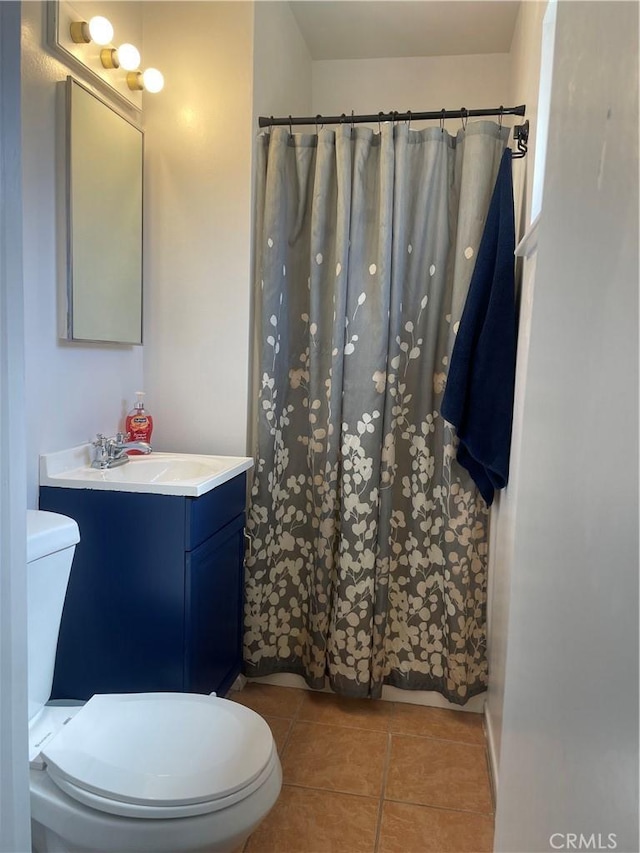 316 Mcbroom Ave, Barstow, CA 92311 - full bath with toilet, tile patterned floors, vanity, and a shower with shower curtain