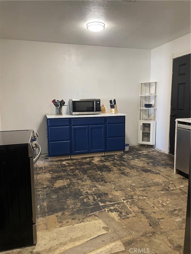 316 Mcbroom Ave, Barstow, CA 92311 - kitchen with appliances with stainless steel finishes, blue cabinetry, light countertops, and a textured ceiling