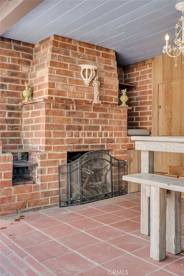 unfurnished living room featuring tile patterned floors and a large fireplace