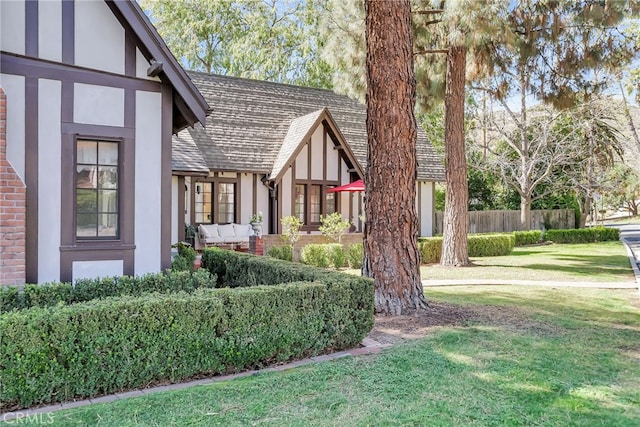 view of yard with outdoor lounge area and fence