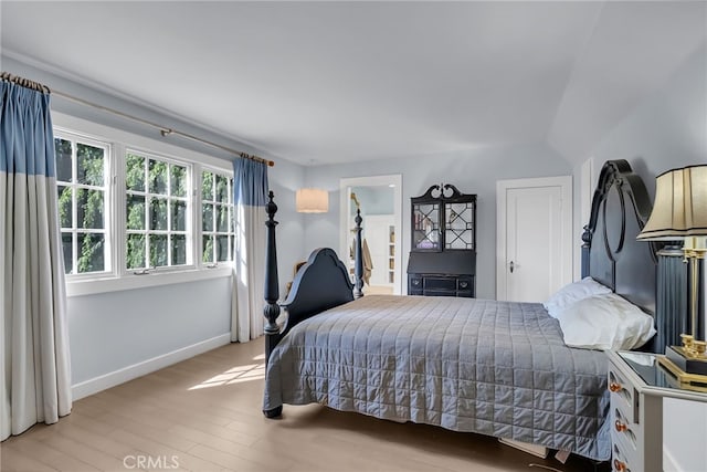 bedroom featuring wood finished floors and baseboards