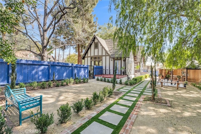 view of yard with a patio, a wooden deck, and a fenced backyard