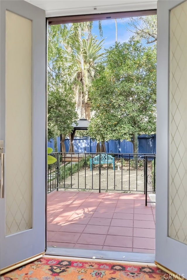 doorway to outside featuring tile patterned flooring