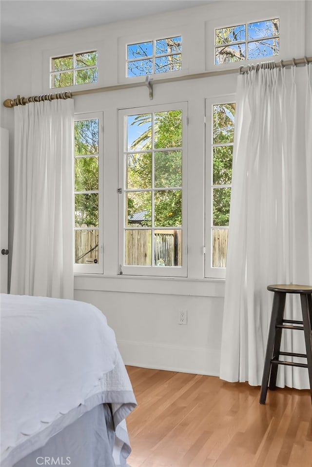 bedroom featuring baseboards and wood finished floors