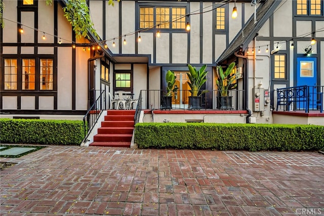 doorway to property featuring stucco siding