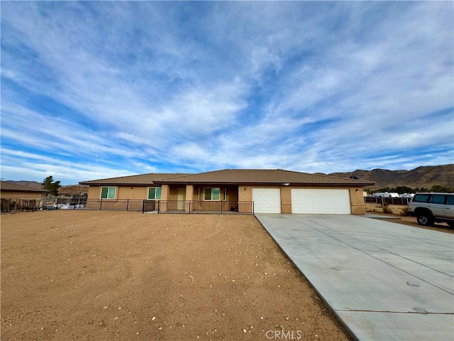 single story home with fence, a garage, driveway, and stucco siding