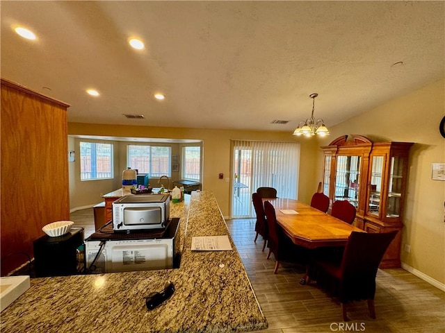 dining area with visible vents, baseboards, a chandelier, recessed lighting, and wood finished floors