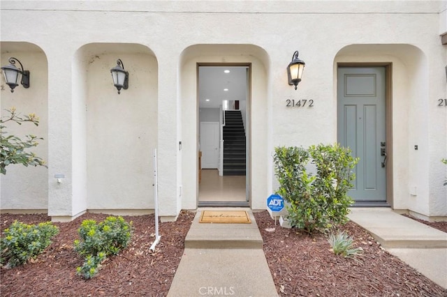 property entrance featuring stucco siding