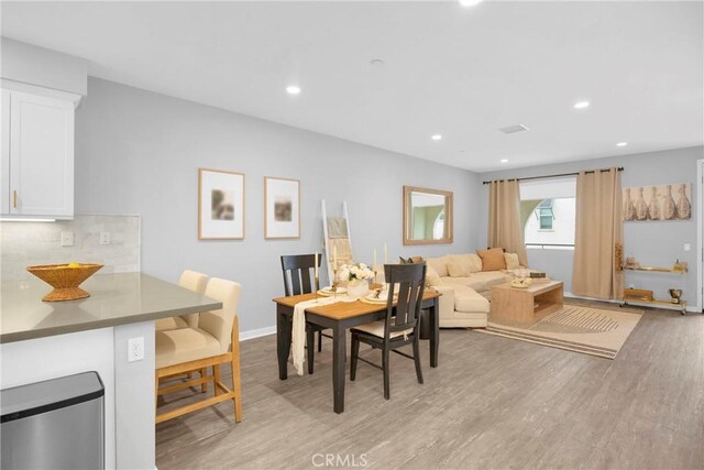 dining space with recessed lighting, baseboards, and light wood-style floors