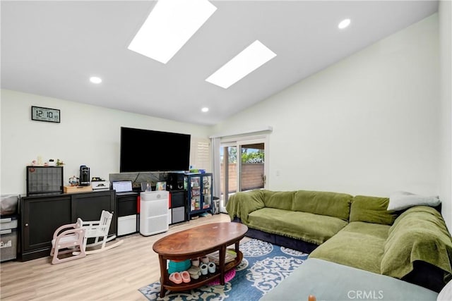 living area featuring recessed lighting, lofted ceiling with skylight, and wood finished floors