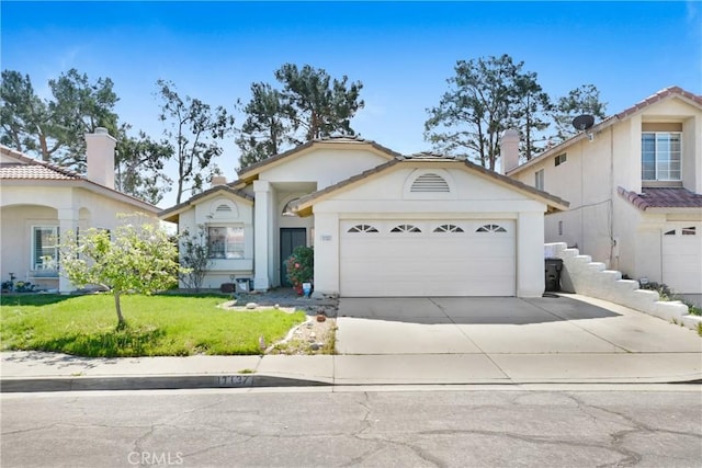 view of front of home featuring a garage, concrete driveway, a front lawn, and stucco siding