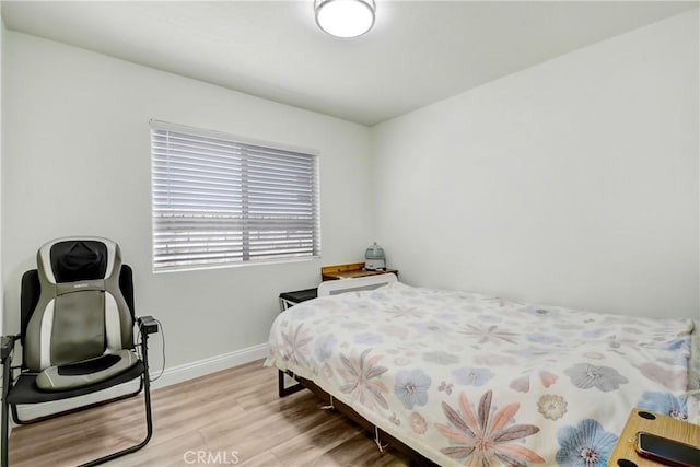 bedroom featuring light wood-style flooring and baseboards