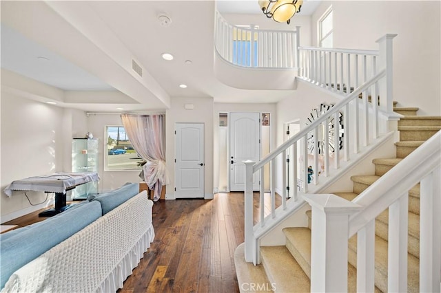 entrance foyer featuring visible vents, dark wood-style flooring, recessed lighting, baseboards, and stairs