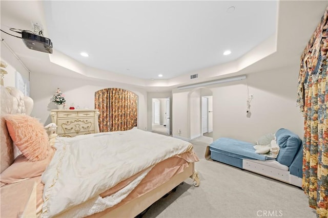 bedroom featuring recessed lighting, visible vents, carpet floors, and arched walkways