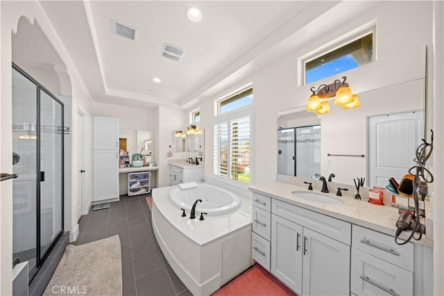 bathroom featuring tile patterned flooring, visible vents, a stall shower, and a sink