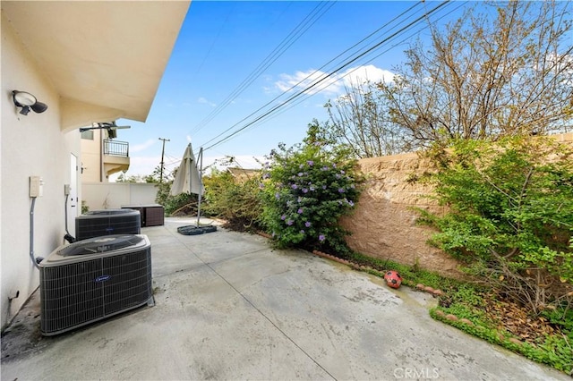 view of patio featuring fence and central AC