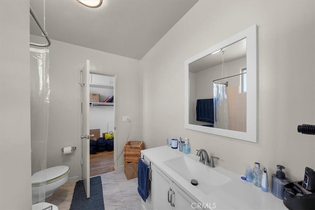 bathroom with marble finish floor, toilet, vanity, and a shower with curtain