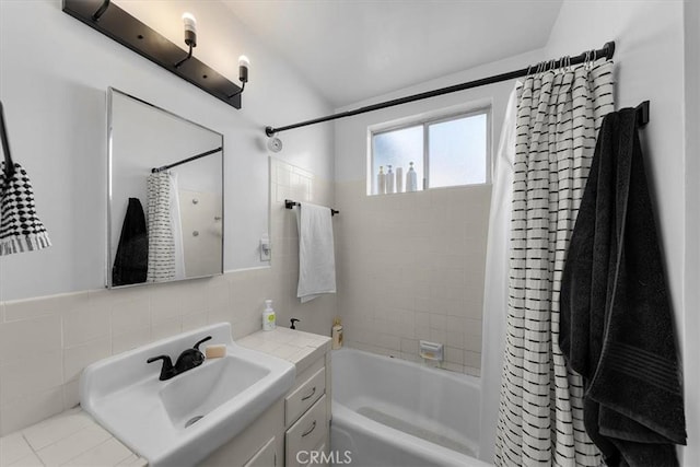 full bath featuring shower / bathtub combination with curtain, backsplash, tile walls, and vanity