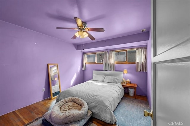 bedroom featuring wood finished floors and a ceiling fan