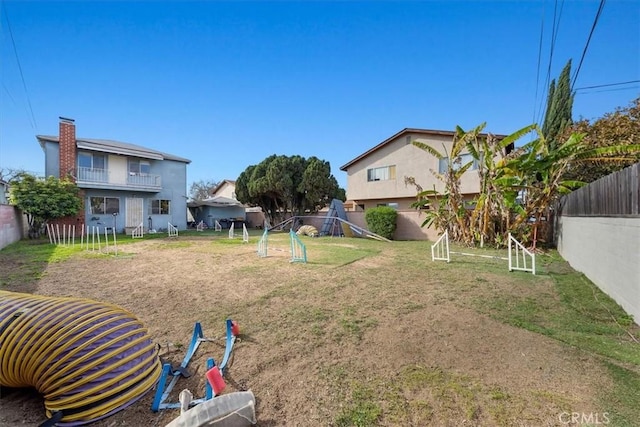 view of yard with a playground and a fenced backyard