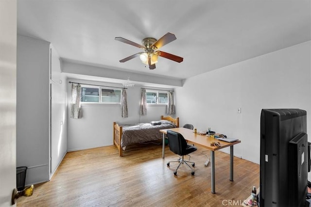 bedroom with a ceiling fan and wood finished floors