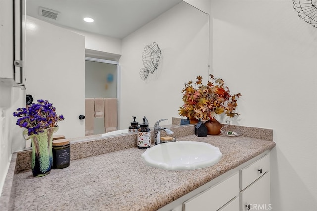 bathroom featuring visible vents and vanity