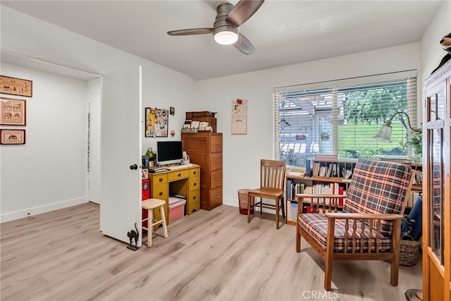 home office featuring baseboards, light wood-style floors, and ceiling fan