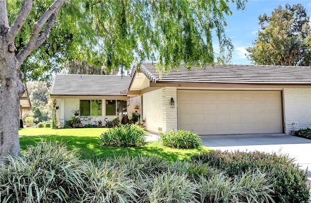 single story home with driveway, a front lawn, a tile roof, a garage, and brick siding