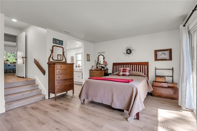 bedroom featuring recessed lighting, light wood-type flooring, visible vents, and ensuite bathroom