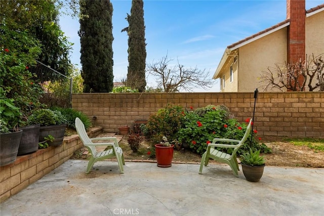 view of patio featuring fence