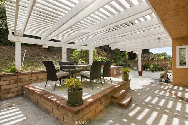 view of patio / terrace with outdoor dining space, a pergola, and fence