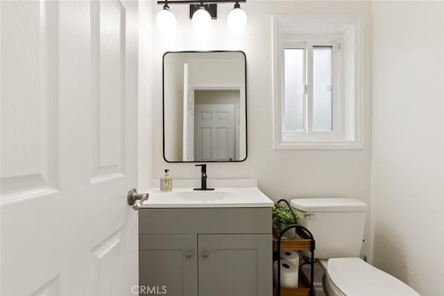 bathroom featuring toilet and vanity