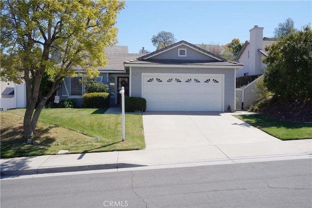 ranch-style house featuring a front lawn, fence, concrete driveway, a garage, and a tiled roof