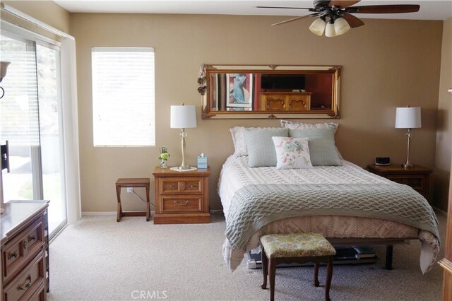 bedroom featuring baseboards, ceiling fan, carpet flooring, and access to outside