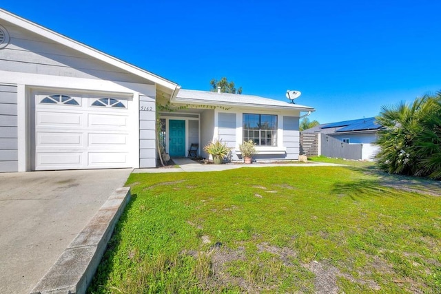 view of front of property with a garage and a front yard