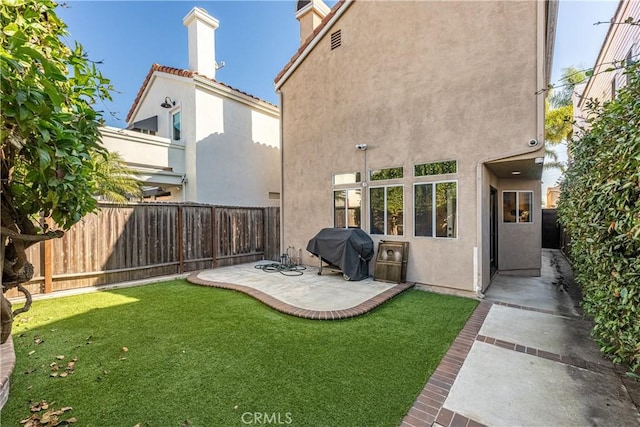 view of yard with a patio area and a fenced backyard