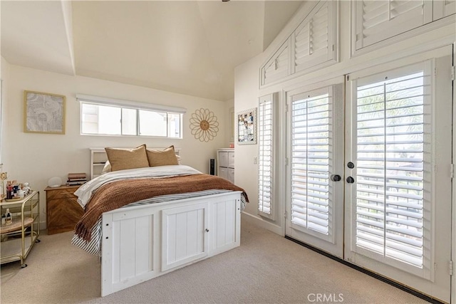 bedroom featuring access to exterior, light colored carpet, and lofted ceiling