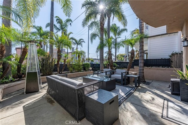 view of patio featuring outdoor lounge area and fence